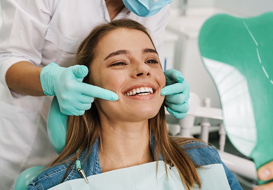 Woman learning how to prevent dental emergencies in La Crosse