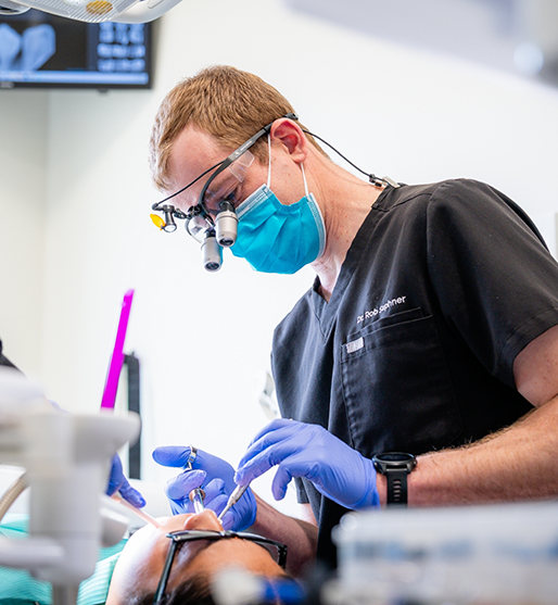 Woman grinning at her dentist during a preventive dentistry checkup