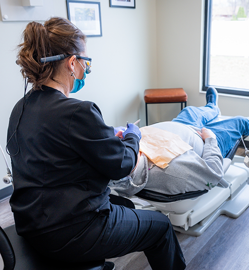 Woman relaxing in dental chair because of sedation dentistry in La Crosse