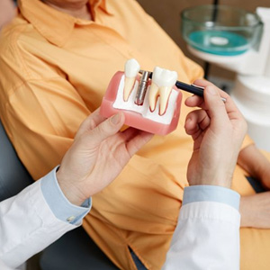 Dentist and patient talking about dental implants during consultation