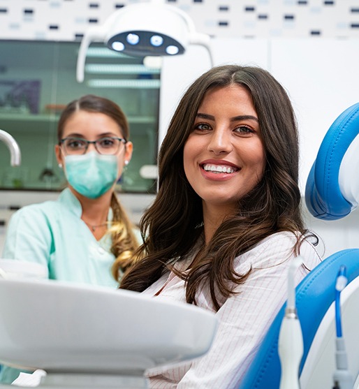 Smiling young woman in dental treatment chair