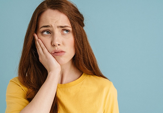 Young woman suffering from a toothache