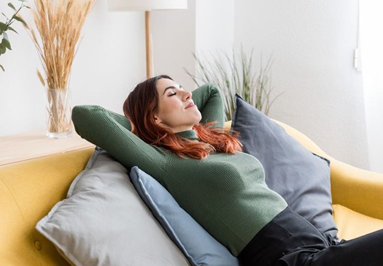 Woman relaxing on her sofa at home