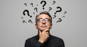 Man with questions wearing thoughtful, curious expression 