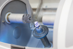 Close-up of CEREC machine creating a dental crown