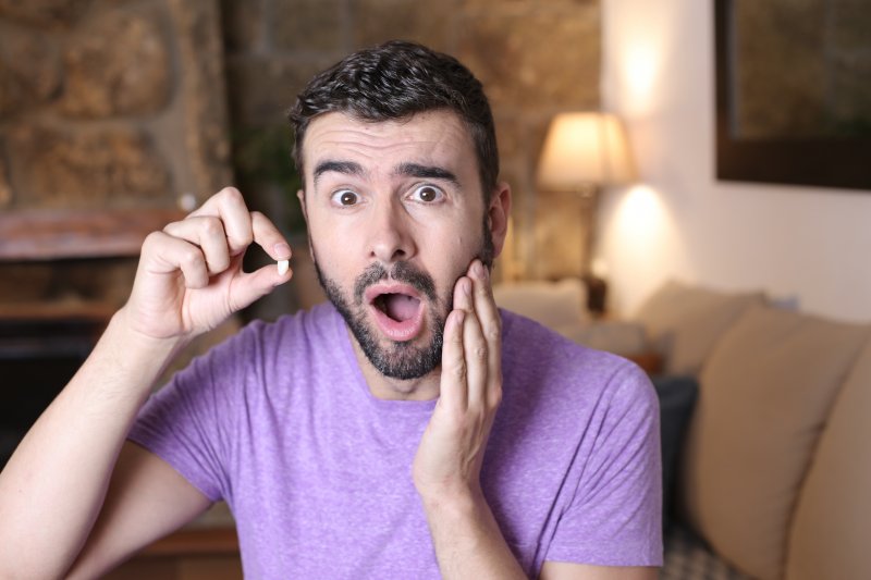 Patient panicked holding their dental crown