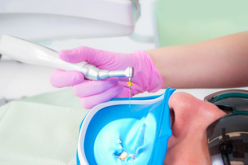 A dentist preparing to give a patient a root canal